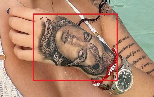 'Medusa' tattoo on the left hand.