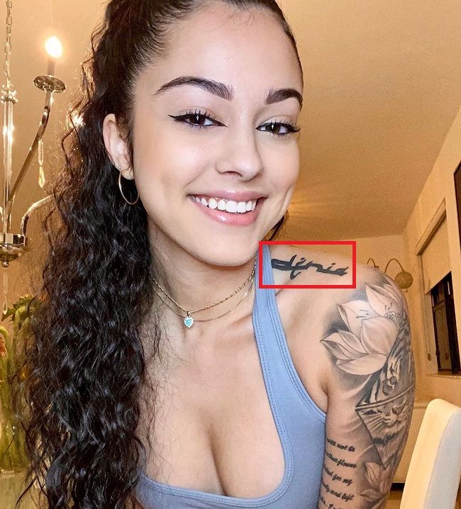 Mother's name tattoo on the left shoulder.