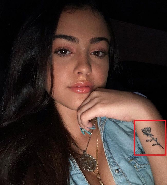 'Rose' tattoo near her left wrist.